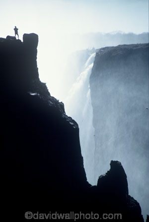 on-the-edge;Victoria-Falls;Zimbabwe;Zambia;southern-Africa;african;silhouette;silhouettes;waterfall;waterfalls;africa;zambezi-river;zambesi;zambeze;rivers;power;alone;solo;top;atop;cliff;cliffs;bluff;bluffs;danger;dangerous;high;person;people;mist;misty;adventure;excite;exciting;heights