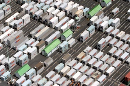 container;containers;yard;asphalt;row;rows;stack;stacked;hut;huts;green;green-roof;green-rooves;green-roofs;neat;orderly