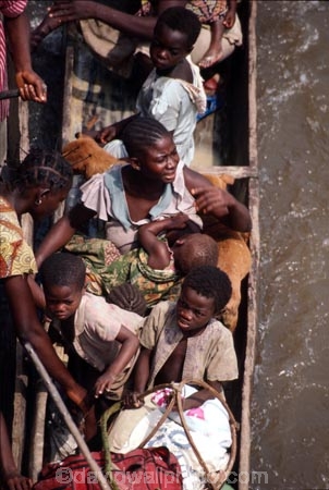 dugout;canoe;canoes;riverboat;person;people;child;children;breastfeed;breastfeeding;mother;baby;crowded;river;ride;riding
