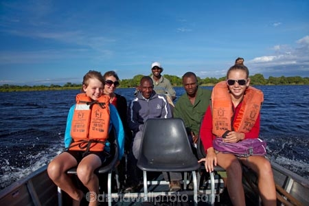 Africa;African;boat;boats;Botswana;boy;boys;child;children;delta;deltas;Endorheic-basin;girl;girls;Guma-Lagoon;inland-delta;internal-drainage-systems;Okavango;Okavango-Delta;Okavango-Swamp;people;person;river-delta;Seven-Natural-Wonders-of-Africa;Southern-Africa;tourism;tourist;tourist-boat;tourist-boats;tourists