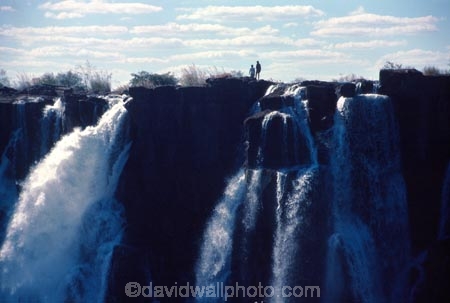 on-the-edge;Victoria-Falls;Zimbabwe;Zambia;southern-Africa;african;silhouette;silhouettes;waterfall;waterfalls;africa;zambezi-river;zambesi;zambeze;rivers;power;alone;solo;top;atop;cliff;cliffs;bluff;bluffs;danger;dangerous;high;person;people;mist;misty;adventure;excite;exciting;heights