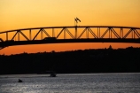 Auckland;Auckland-Harbour-Bridge;bridge;bridges;dusk;evening;flag;flags;N.I.;N.Z.;New-Zealand;NI;nightfall;North-Island;NZ;orange;silhouette;silhouettes;sky;span;spans;steel;structure;structures;sunset;sunsets;transport;transportation;twilight;Waitemata-Harbor;Waitemata-Harbour