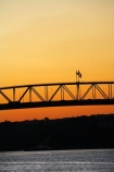 Auckland;Auckland-Harbour-Bridge;bridge;bridges;dusk;evening;flag;flags;N.I.;N.Z.;New-Zealand;NI;nightfall;North-Island;NZ;orange;silhouette;silhouettes;sky;span;spans;steel;structure;structures;sunset;sunsets;transport;transportation;twilight;Waitemata-Harbor;Waitemata-Harbour
