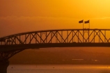 Auckland;Auckland-Harbour-Bridge;bridge;bridges;dusk;evening;flag;flags;infrastructure;N.I.;N.Z.;New-Zealand;NI;nightfall;North-Is.;North-Island;Nth-Is;NZ;orange;road-bridge;road-bridges;silhouette;silhouettes;sky;span;spans;steel;structure;structures;sunset;sunsets;traffic-bridge;traffic-bridges;transport;transportation;twilight;Waitemata-Harbor;Waitemata-Harbour
