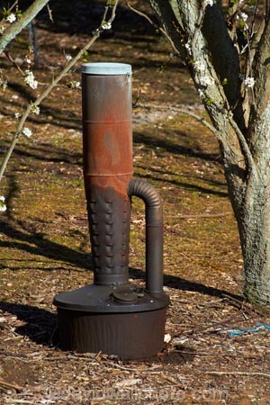 Smoke pot for frost fighting on orchard, Conroys Gully, near Alexandra,  Central Otago, South Island, New Zealand