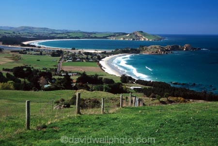 Karitane;Otago;coast;beach;beaches;water;wave;waves;ocean;sea;rural;town;settlement;curve;grass;green;tree;trees;fence;blue;sky;summer;sunny
