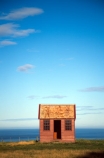 scenic;hilltop;sea;coastal;lone;lonely;hut;cottage;farm;settler;early;history;old;oldest;storehouse;Johny-Jones;rural;farm-building;wood;wooden;New-Zealand