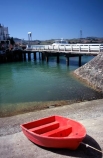 cement;color;colour;concrete;dingys;dock;docked;harbor;harbour;orange;ramp;red;rowboat;water