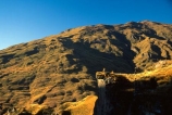 Queenstown;Central-Otago;Skippers-Canyon;canyon;mountain-biker;mountain-bike;mountain;mountains;rocks;rock;rocky;shadow;shadows;shadowy;sky;blue;clear-sky;auburn;brown;grassy;distant;distance