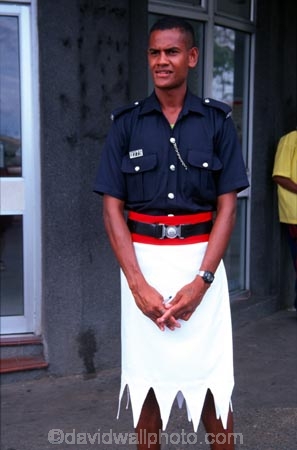 guard;guarding;stand;standing;uniform;black;white;shirt;belt;police;policeman;policemen;police-officer;officer;patrol;lava-lava;doorway;policing-;cop